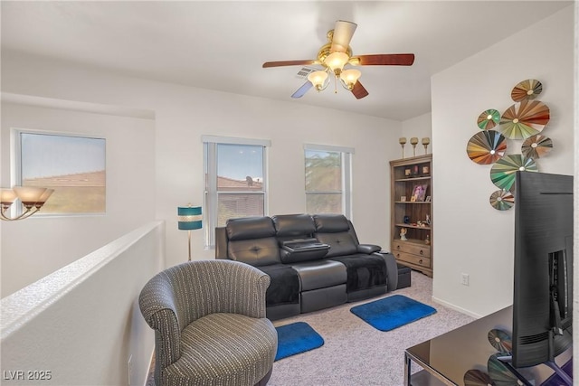 carpeted living room with a ceiling fan
