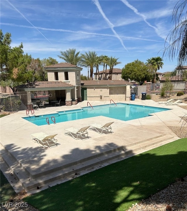 pool featuring a patio and fence