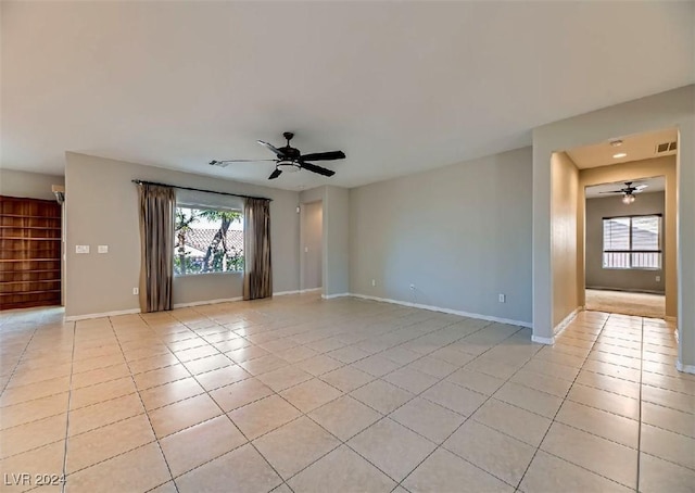 tiled spare room featuring ceiling fan