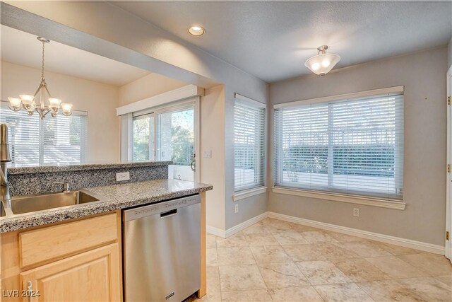 kitchen with an inviting chandelier, sink, hanging light fixtures, stainless steel dishwasher, and light brown cabinetry