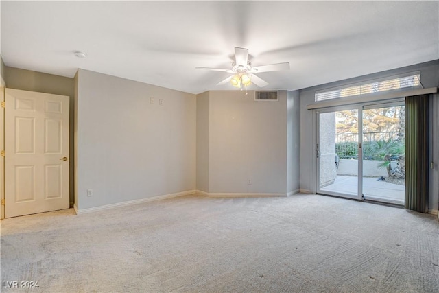 empty room featuring ceiling fan and light carpet