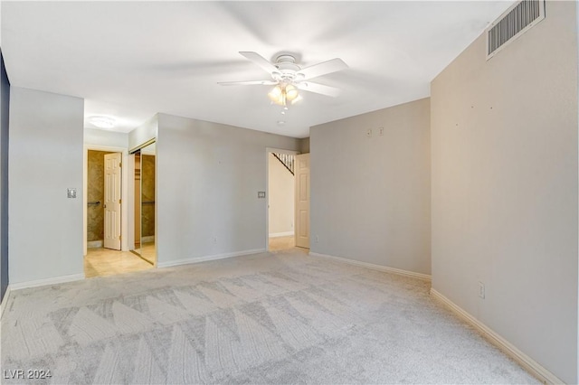 carpeted spare room with ceiling fan