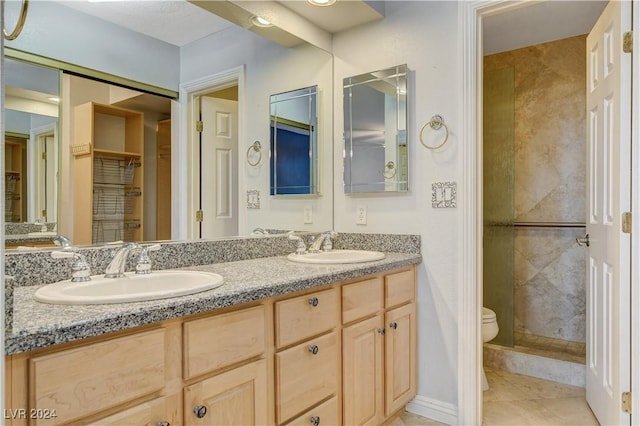 bathroom with tile patterned floors, vanity, and toilet