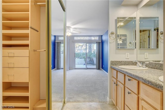 bathroom featuring tile patterned floors, ceiling fan, and vanity