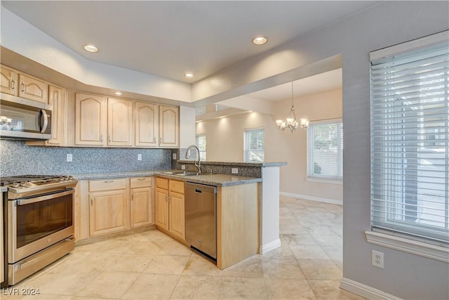 kitchen featuring tasteful backsplash, light stone countertops, light brown cabinetry, appliances with stainless steel finishes, and kitchen peninsula