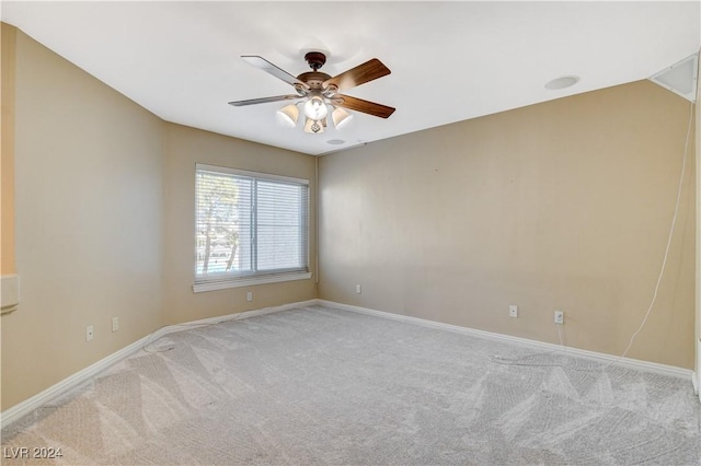 carpeted spare room with ceiling fan