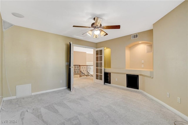 spare room featuring ceiling fan and light colored carpet