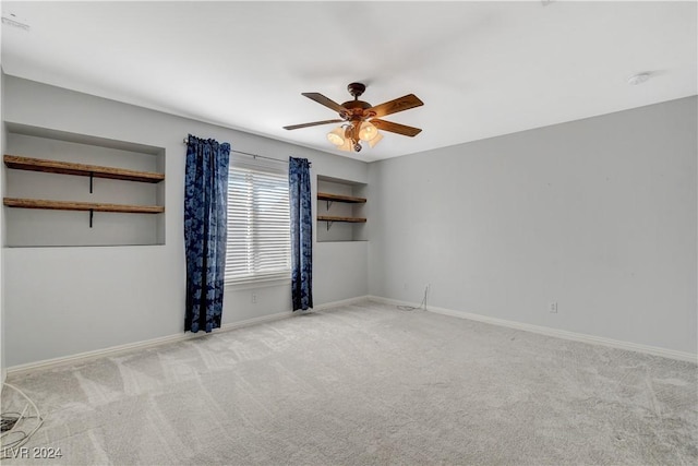 unfurnished room with light carpet and ceiling fan