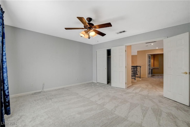 unfurnished room featuring light colored carpet and ceiling fan