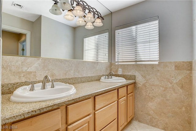 bathroom featuring tile patterned flooring, vanity, and tile walls