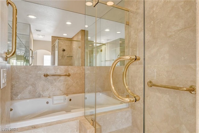 bathroom with separate shower and tub