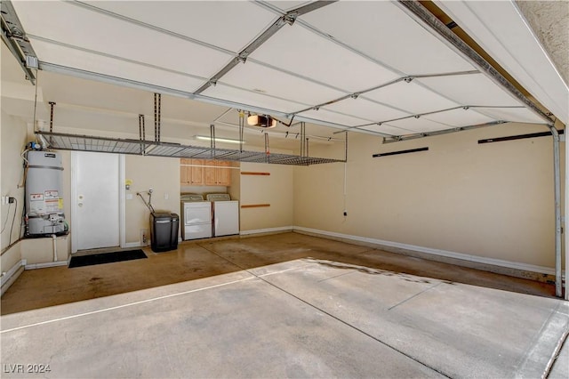 garage featuring separate washer and dryer, strapped water heater, and a garage door opener