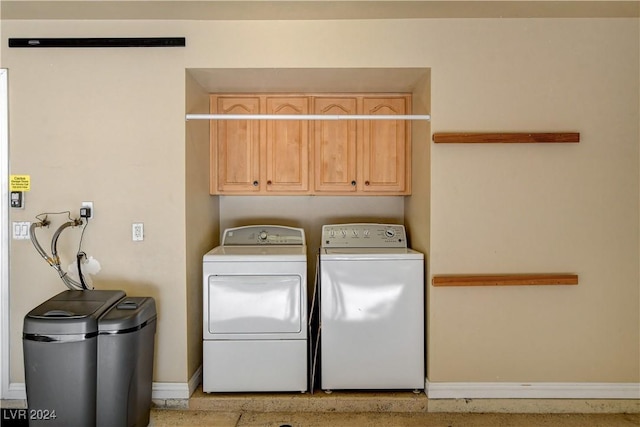 laundry room featuring cabinets and washing machine and dryer