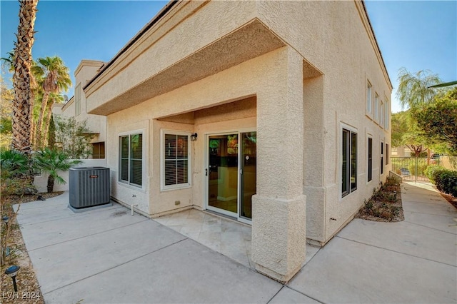 rear view of property with a patio and central AC unit