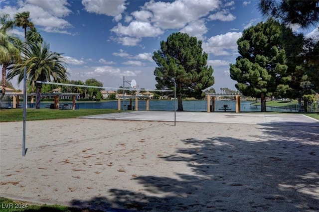 surrounding community featuring a water view and volleyball court