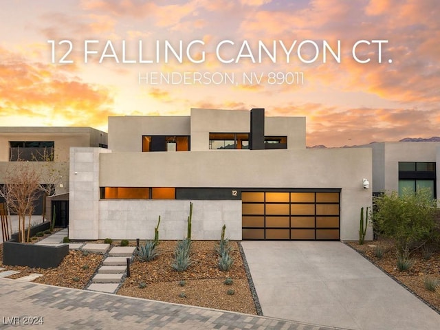 view of front of home with a balcony and a garage