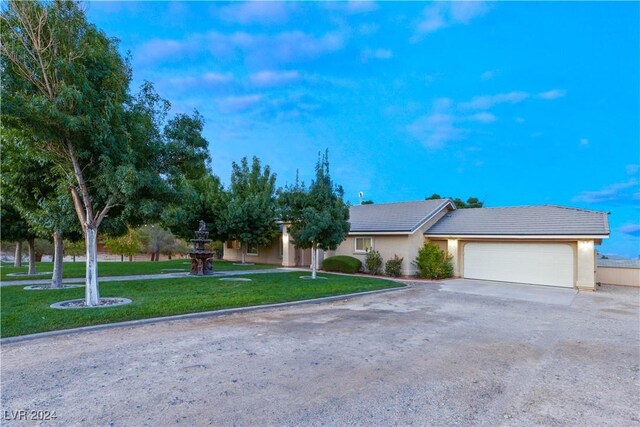 view of front of house featuring a garage and a front yard