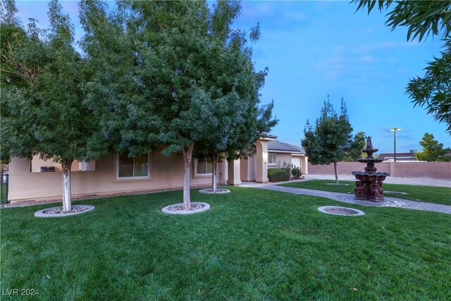 view of property hidden behind natural elements with a front lawn