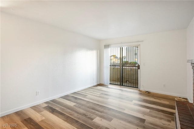 spare room featuring light hardwood / wood-style floors