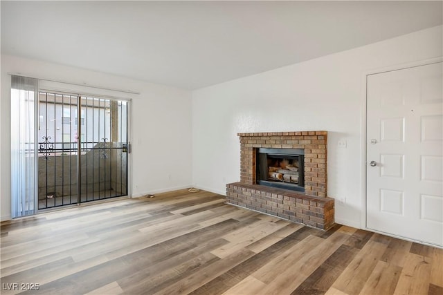 unfurnished living room featuring light hardwood / wood-style floors and a fireplace