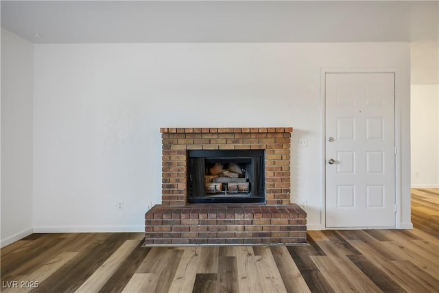 details with hardwood / wood-style flooring and a fireplace