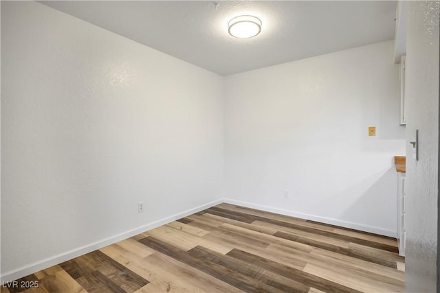 unfurnished room with hardwood / wood-style flooring