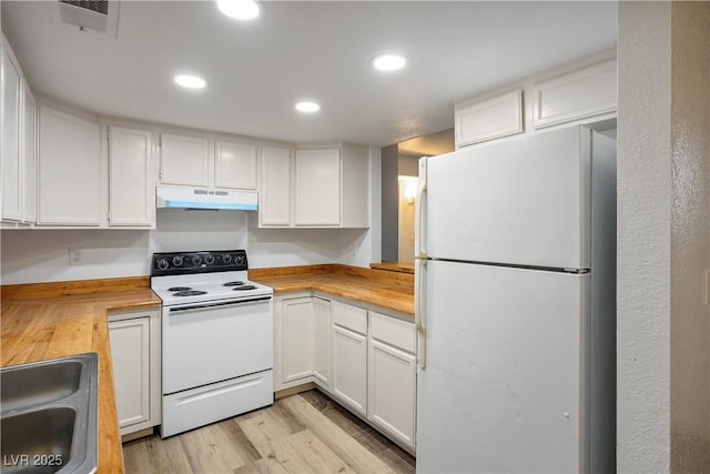 kitchen with butcher block counters, white cabinetry, sink, and white appliances