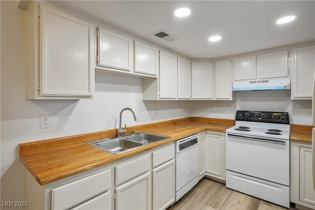 kitchen with white cabinets, light wood-type flooring, white appliances, and sink