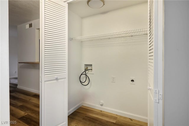 laundry room with hardwood / wood-style flooring, electric dryer hookup, and hookup for a washing machine