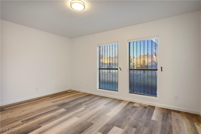 unfurnished room with light hardwood / wood-style flooring