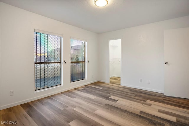 empty room with hardwood / wood-style flooring