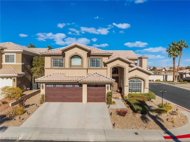 mediterranean / spanish-style home featuring a garage