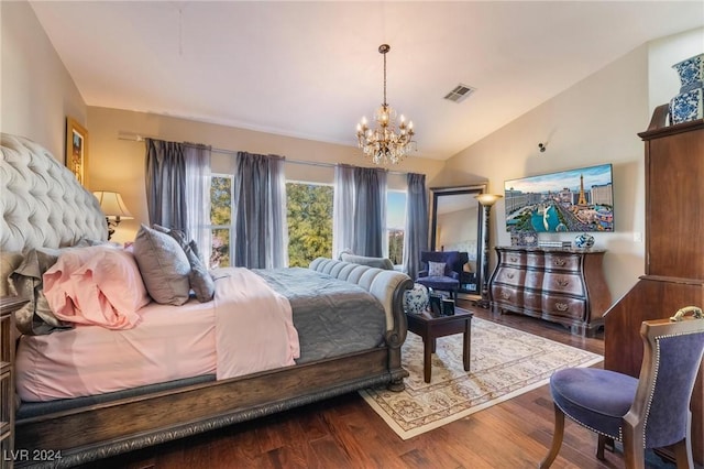 bedroom with hardwood / wood-style flooring, lofted ceiling, and a notable chandelier