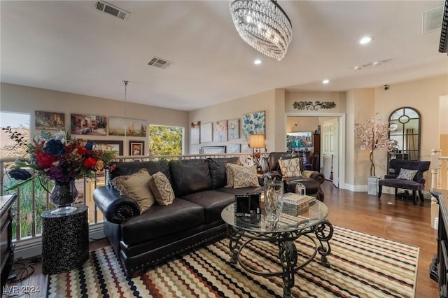 living room featuring a notable chandelier, hardwood / wood-style flooring, and baseboard heating