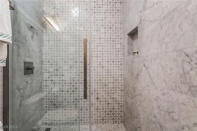 bathroom featuring a shower with shower door