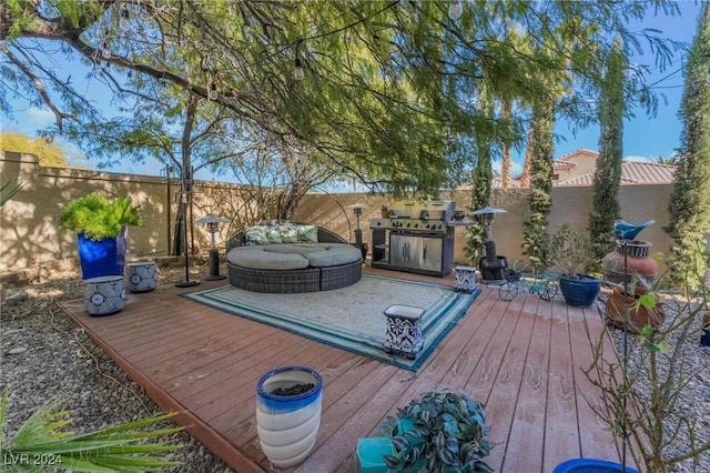 wooden deck featuring an outdoor hangout area and grilling area