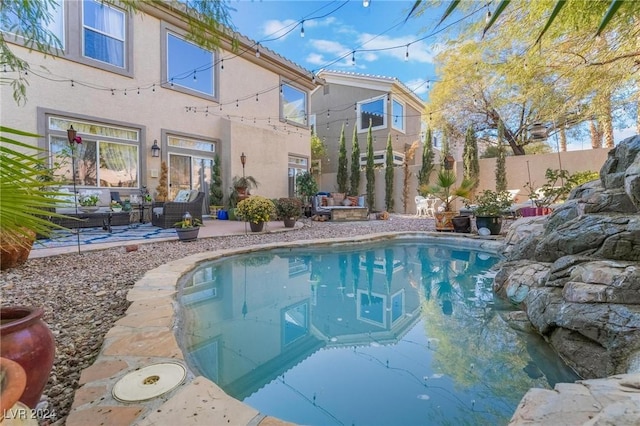 view of swimming pool with an outdoor living space and a patio