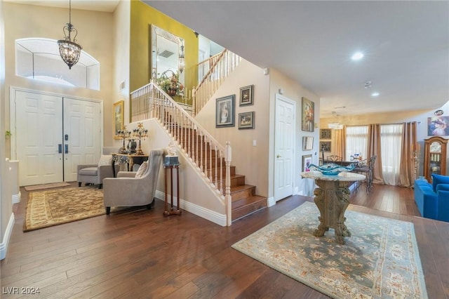 foyer with dark hardwood / wood-style flooring and an inviting chandelier