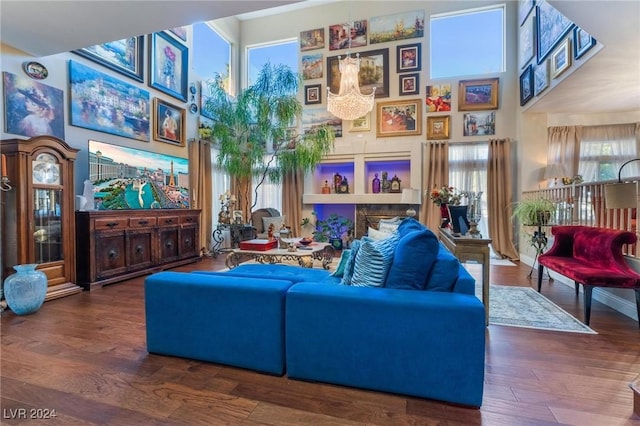 living room with hardwood / wood-style flooring and a towering ceiling