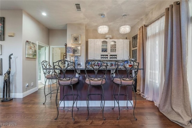 dining area featuring dark wood-type flooring