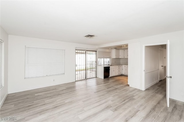 unfurnished living room with light wood-type flooring and sink