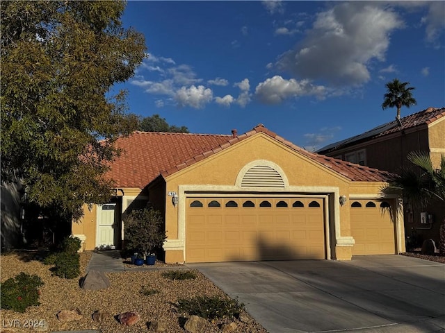 mediterranean / spanish-style home featuring a garage