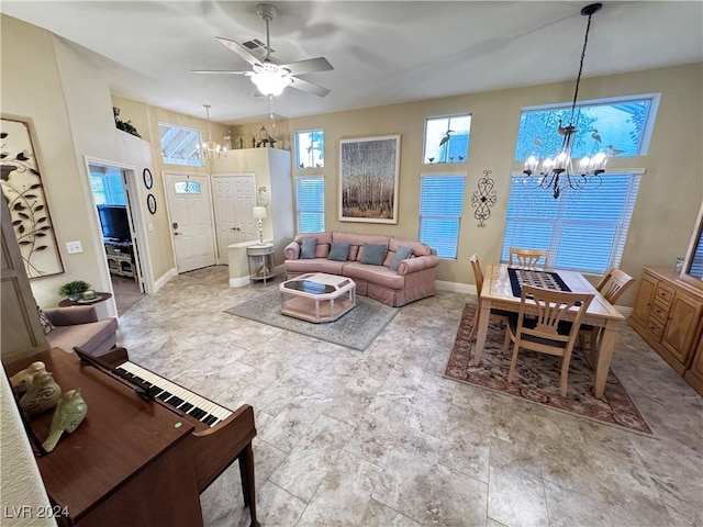 living room with ceiling fan with notable chandelier