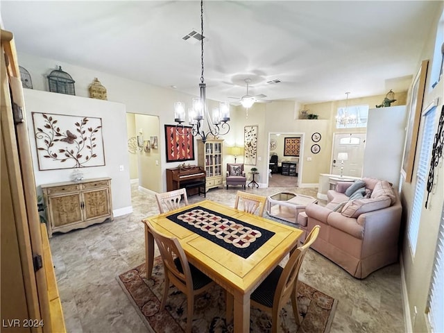 dining room featuring ceiling fan with notable chandelier