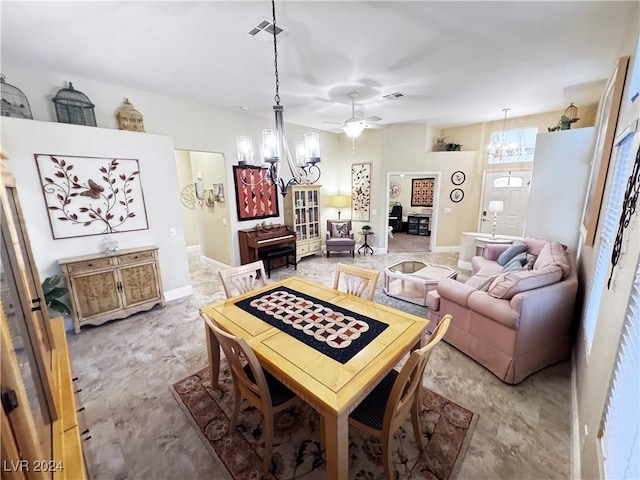 dining room featuring ceiling fan with notable chandelier