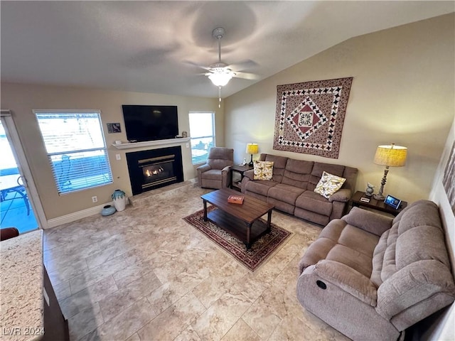 living room featuring ceiling fan and lofted ceiling