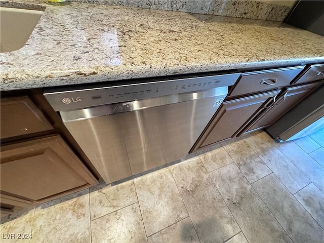 details featuring light stone countertops and dishwasher