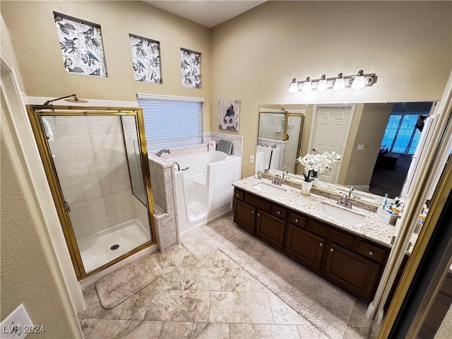 bathroom featuring tile patterned flooring, vanity, and shower with separate bathtub