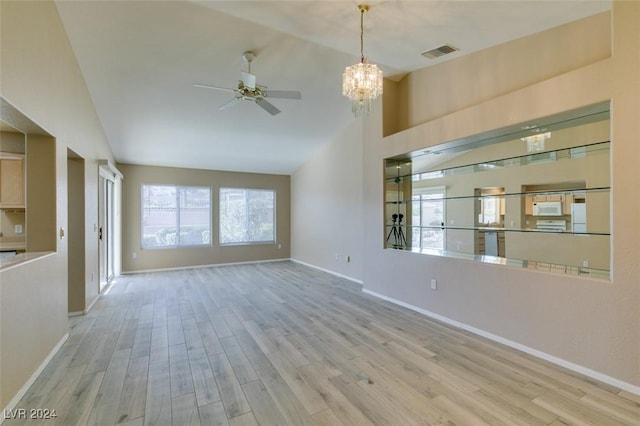 interior space featuring ceiling fan with notable chandelier, light hardwood / wood-style floors, and lofted ceiling