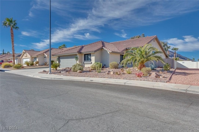 mediterranean / spanish-style home with a garage